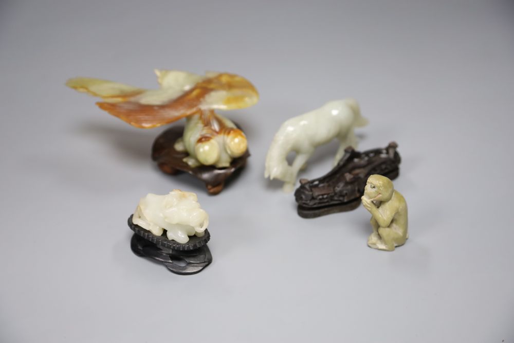 A Chinese jade figure of a buffalo, a hardstone horse and carp and a soapstone monkey